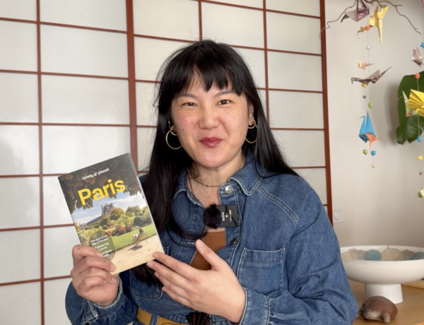 Fabienne holding the 2026 Lonely Planet Paris Guidebook