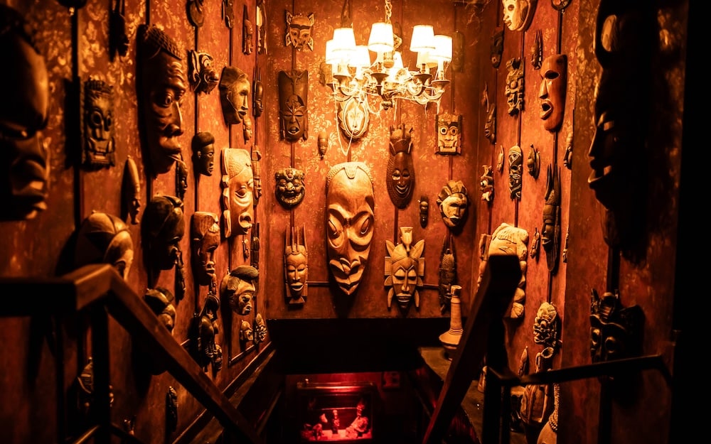 Entrance of a basement with masks from an escape room in Paris